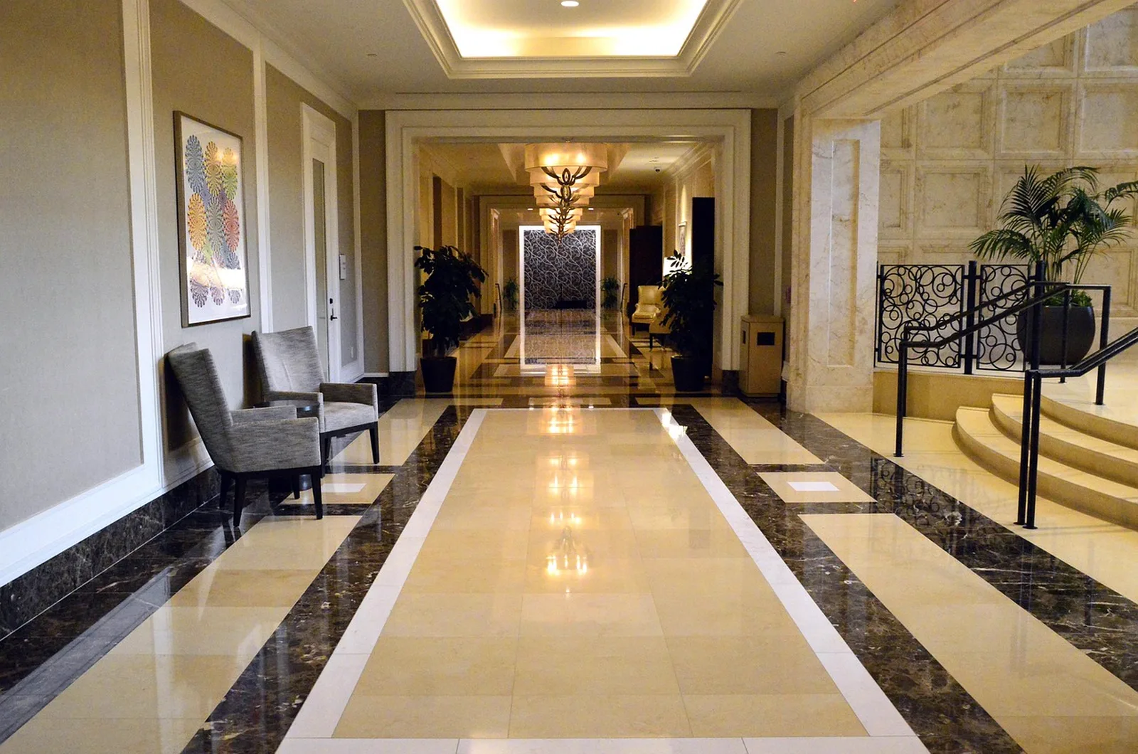 Disney's Saratoga Springs Resort & Spa: A luxurious hotel hallway featuring polished marble floors, comfortable armchairs, and elegant lighting.