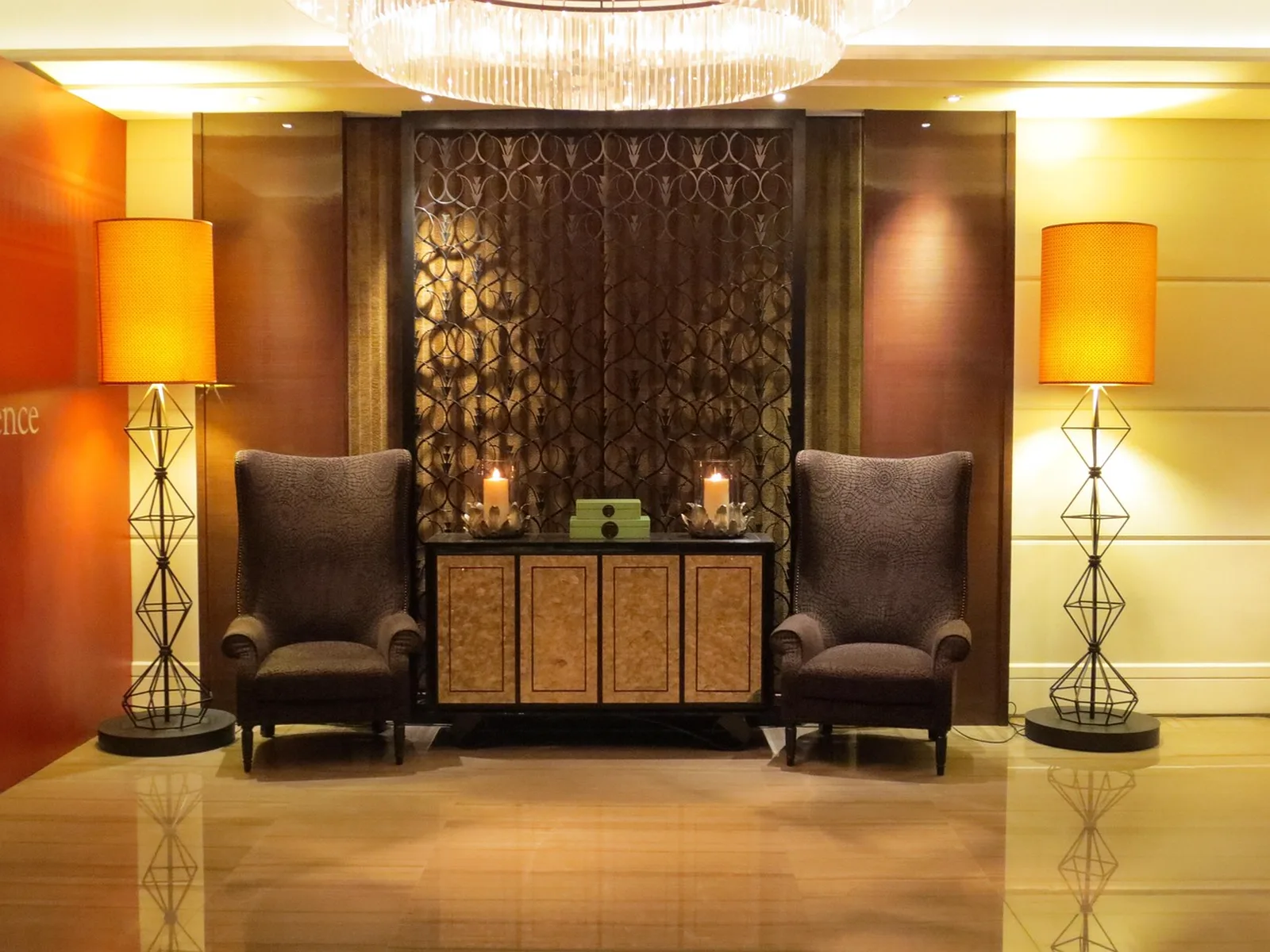 Disney's Animal Kingdom Lodge: An elegant luxury hotel lobby seating area with two armchairs, decorative lamps, and a polished floor.