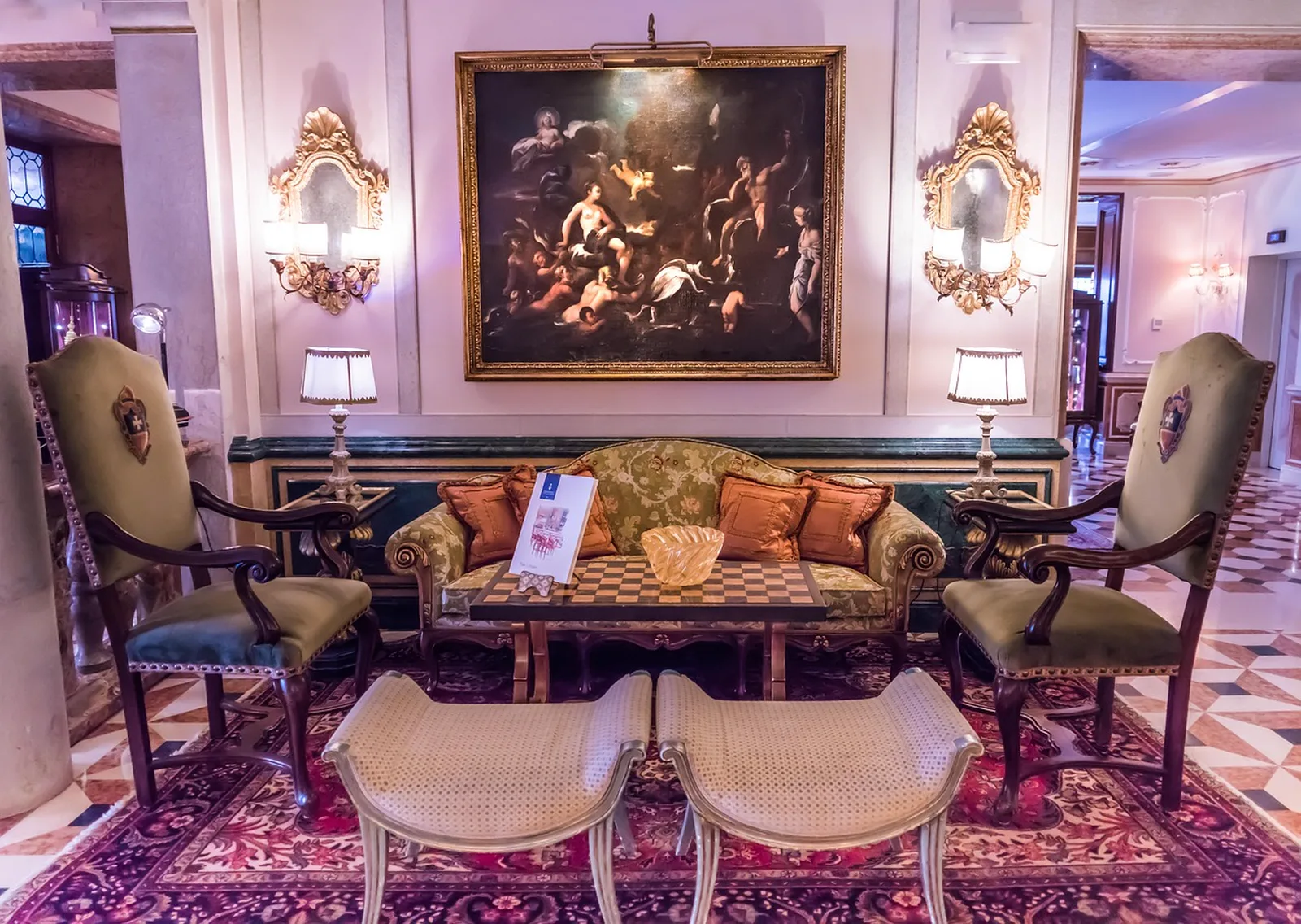 Bay Lake Tower at Disney's Contemporary Resort: An elegant seating area in a luxury hotel lobby features ornate armchairs, a sofa, and a classical framed painting.