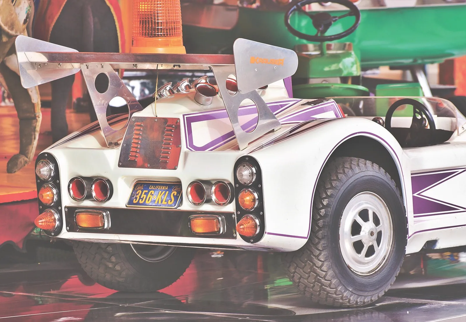 Fun Town: A close-up view of a miniature race car on a children's fairground carousel ride.