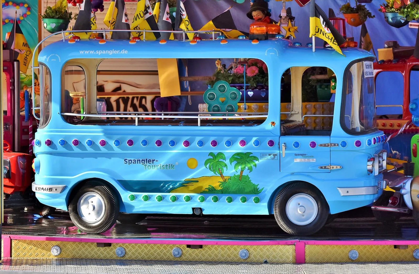 Mickey's Toontown: A bright blue mini-bus vehicle on a children's carnival carousel ride.