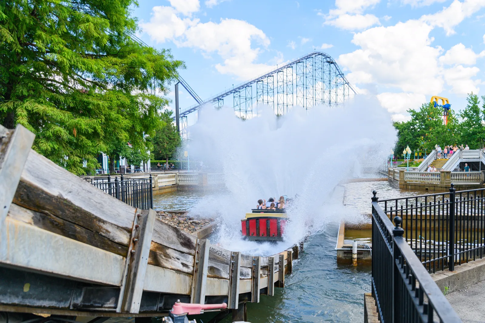 Bayou Country: A boat creates a massive spray of water upon landing at the bottom of an amusement park water ride.