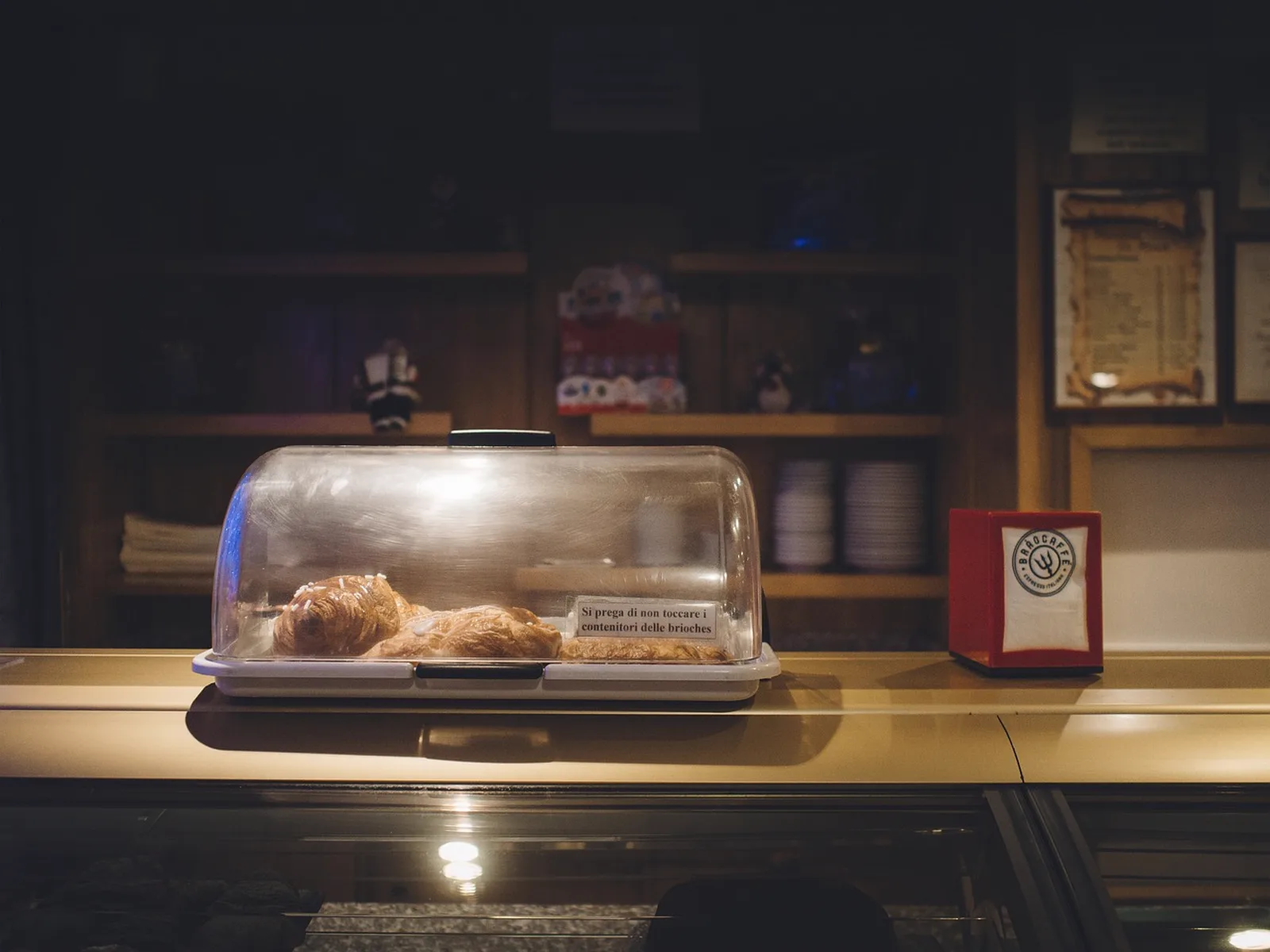 Burger Kitchen: Pastries inside a clear display case sit on a counter.