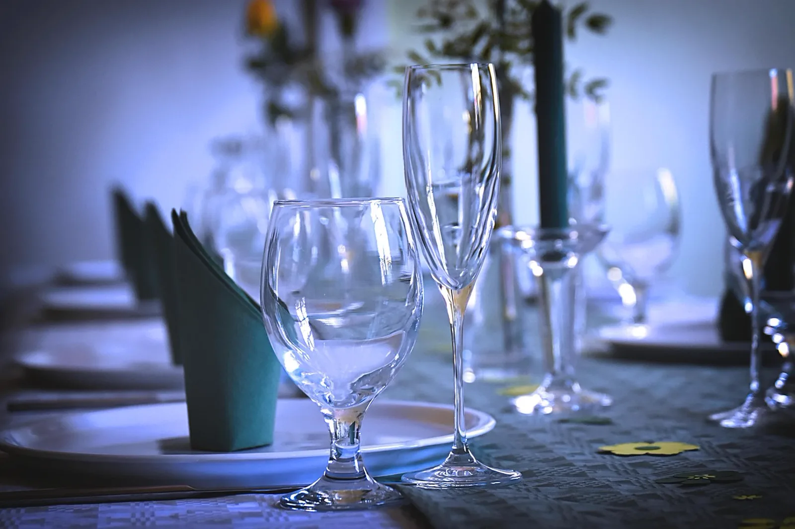 Atlantic: A close-up view of elegant champagne glasses, wine goblets, and folded napkins on a dining table.