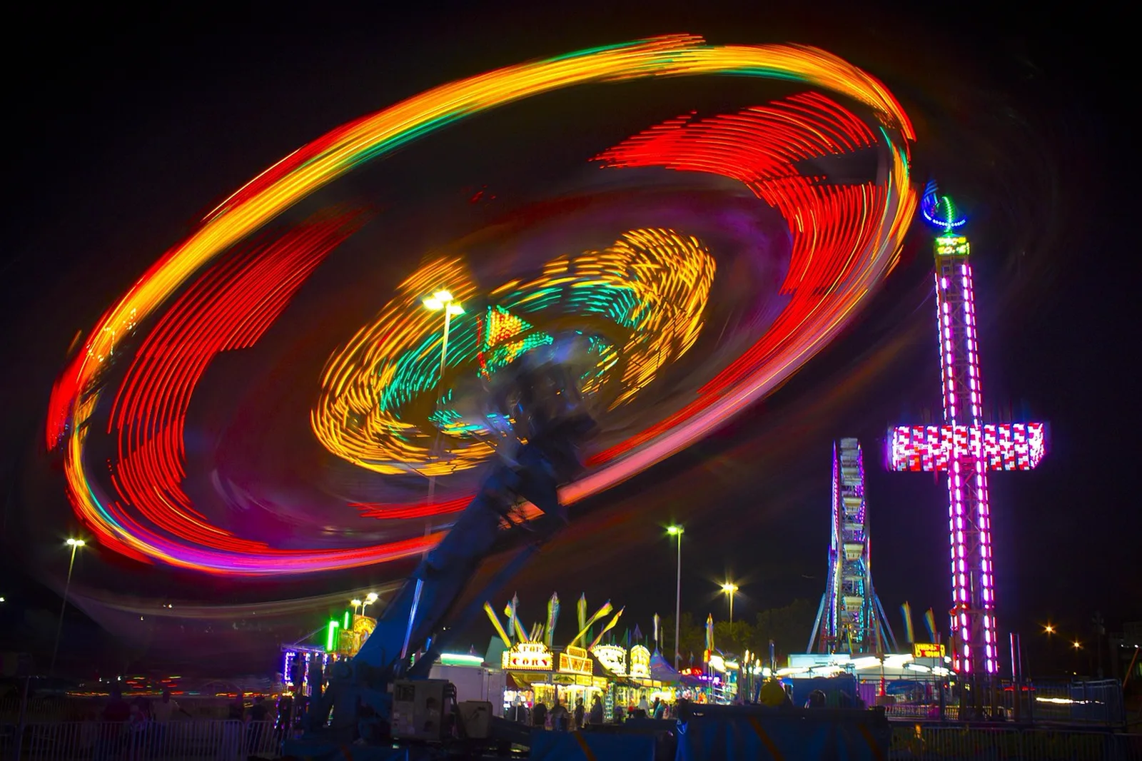 BIONICLE Blaster: A long exposure photo at night shows colorful light streaks from a fast spinning fairground ride.
