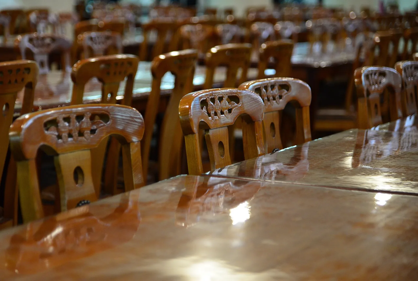 Chef Art Smith's Homecomin': Rows of polished wooden chairs and glossy tables inside an empty dining room.
